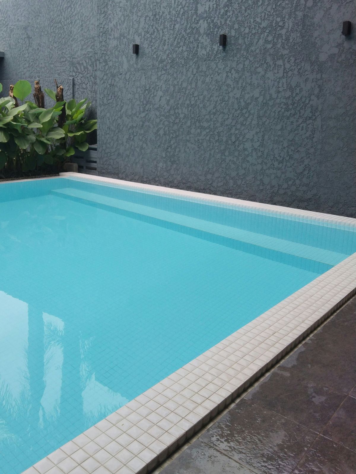 Modern residential swimming pool with tiled steps