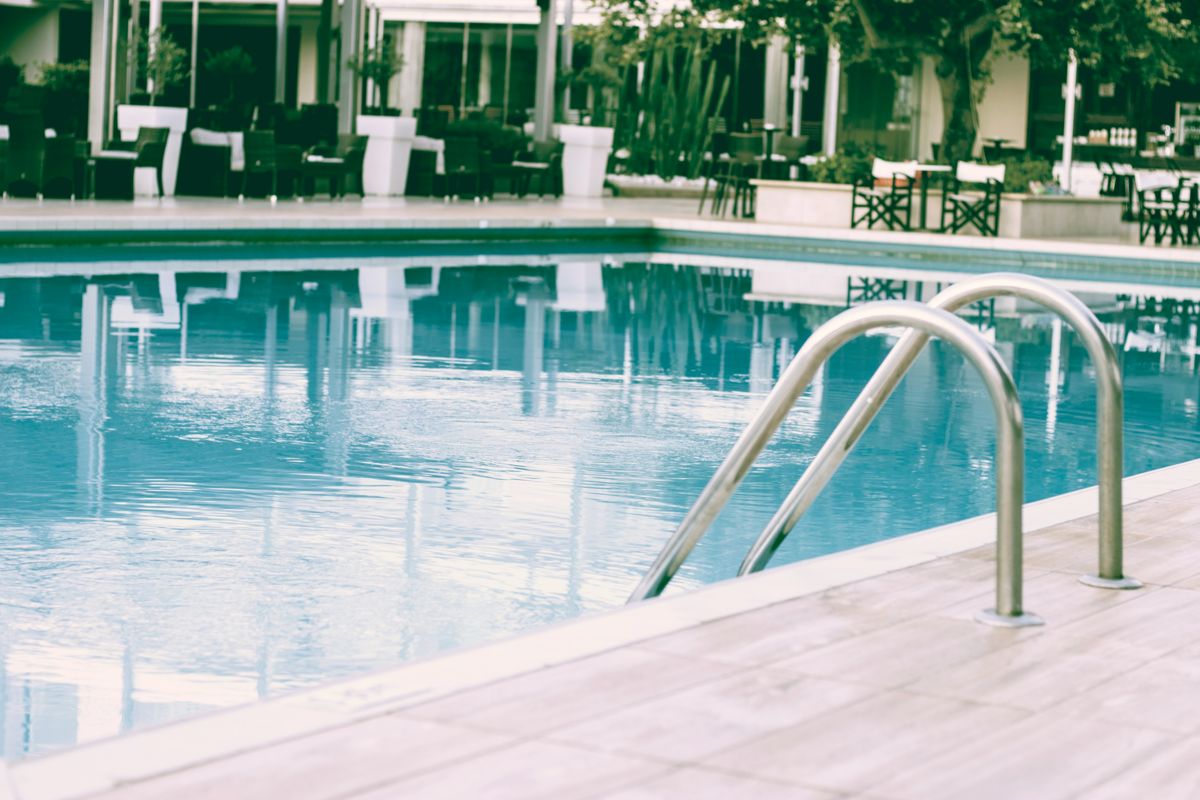 Resort-style pool deck with lounge furniture